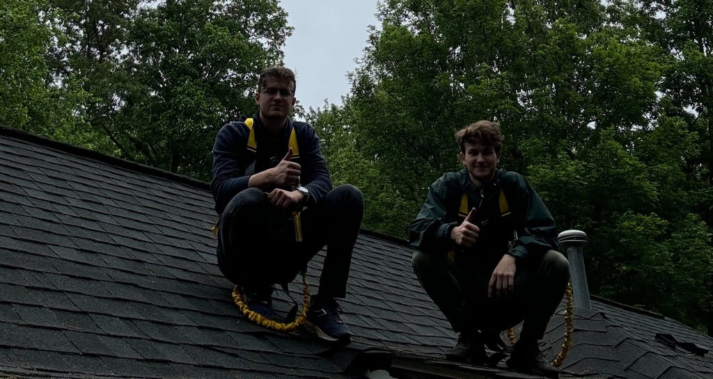 2 owners of studs gutters sitting on roof
