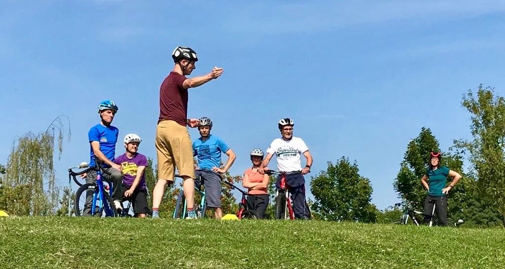 a cycle coach is instructing a group of riders
