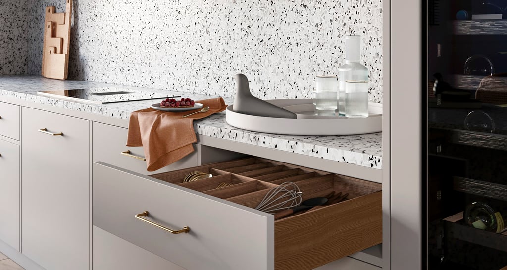 a kitchen with a drawer full of utensils and a knife