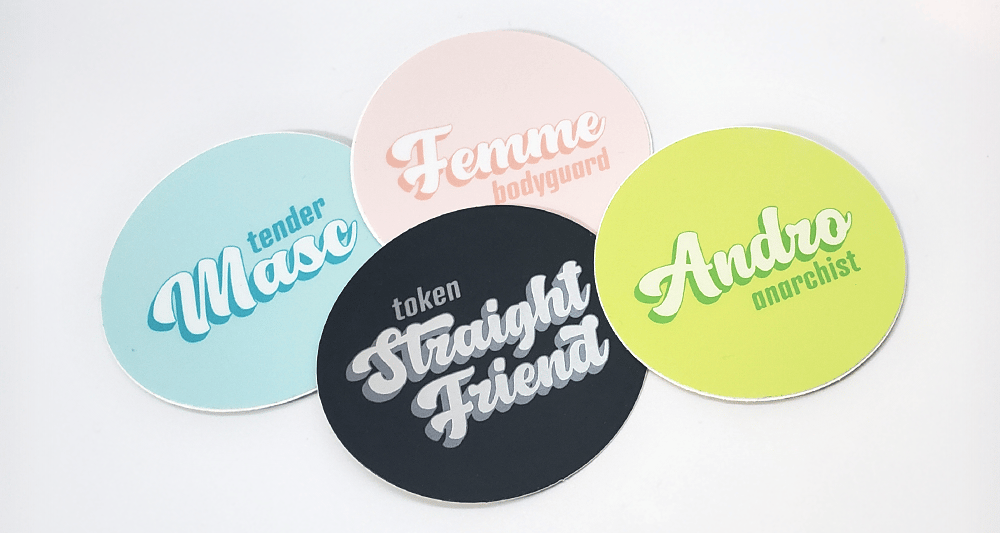 a pile of four stickers with queer identity themes