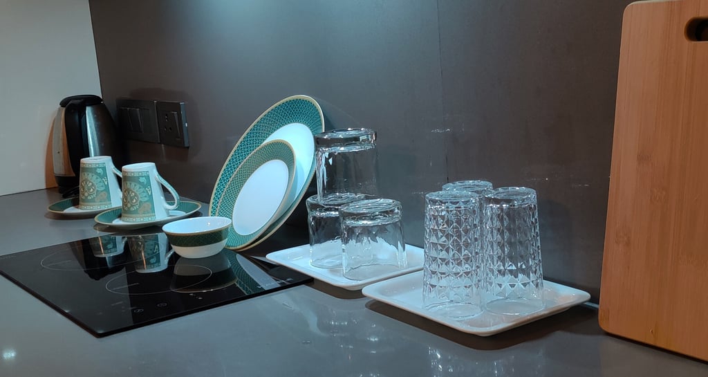 a kitchen counter top with a plate and glasses