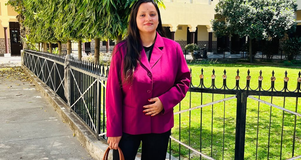 a woman in a pink jacket and black pants