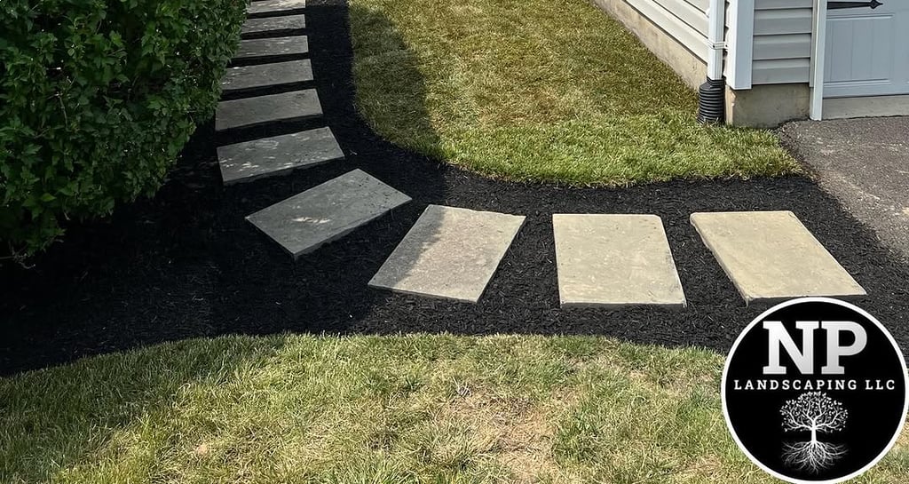 excellent landscaping and hardscaping of grass, stones and trees by NP Landscaping