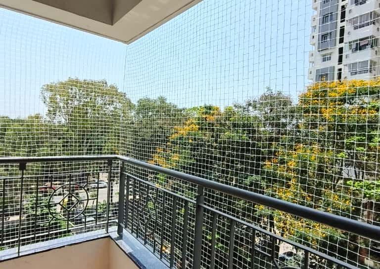 Close-up of a sturdy pigeon net perfectly fitted on a balcony in Arekere.