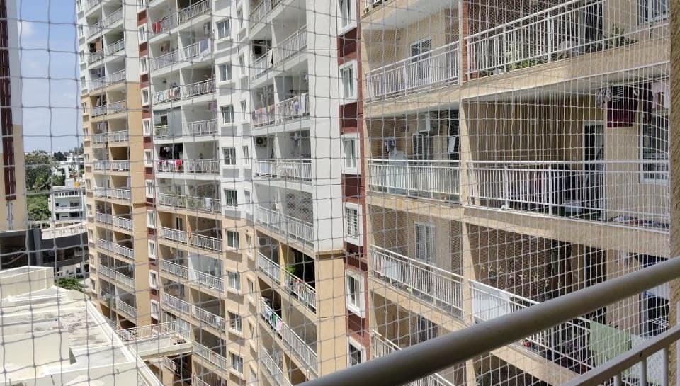 Evening view of a home in Kolathur with pigeon nets blending seamlessly into the architecture.