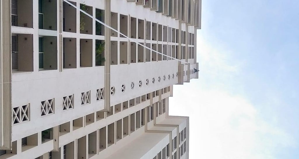Close-up of a securely installed pigeon net on an apartment duct in Sholinganallur.