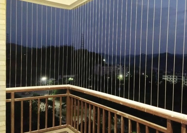 Evening shot of a home in Anna Nagar with invisible grills softly illuminated by ambient light.