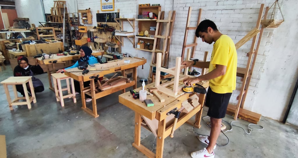 Man and ladies attending a basic woodwork