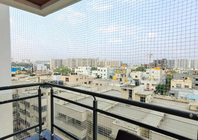 Completed pigeon net installation blending seamlessly with the building’s exterior in Koramangala.