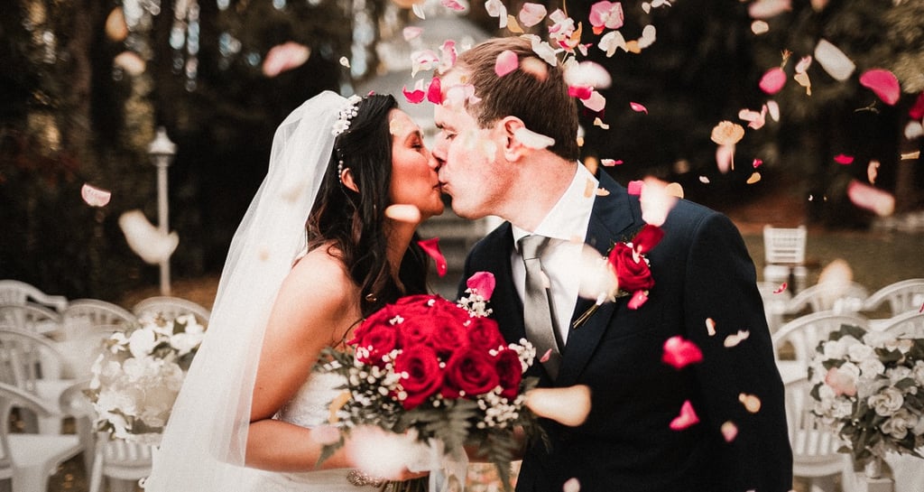 a bride and groom kissing in a wedding ceremony