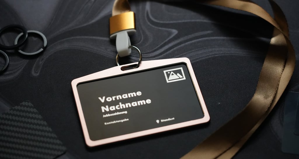 A personalized black plastic ID card holder with a gold lanyard on a dark marble surface.