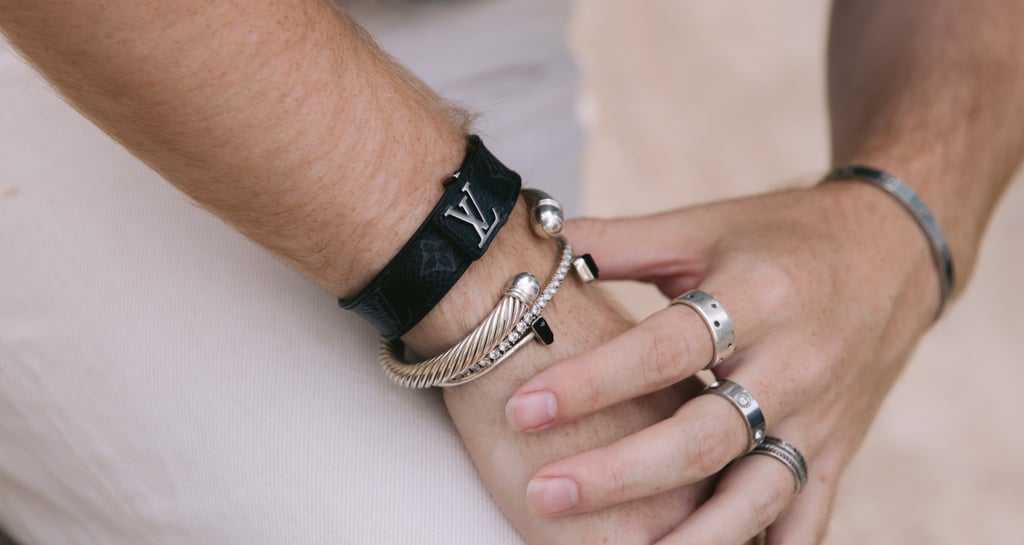 a man and woman holding hands with bracelets