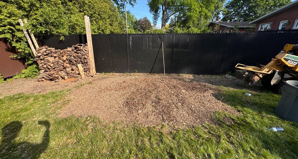 Professional stump removal using a grinder on a residential property in West Island