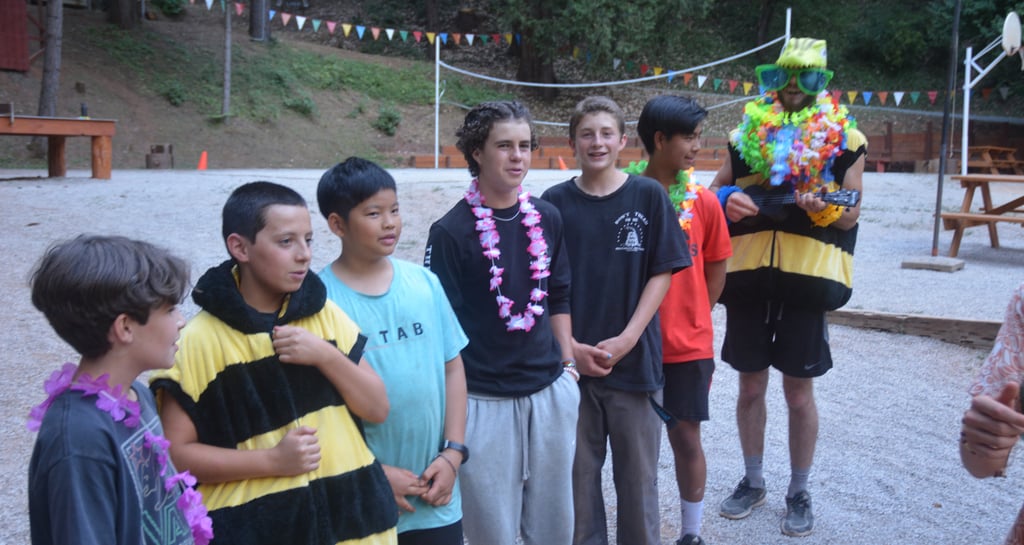a group of campers lined up for dinner
