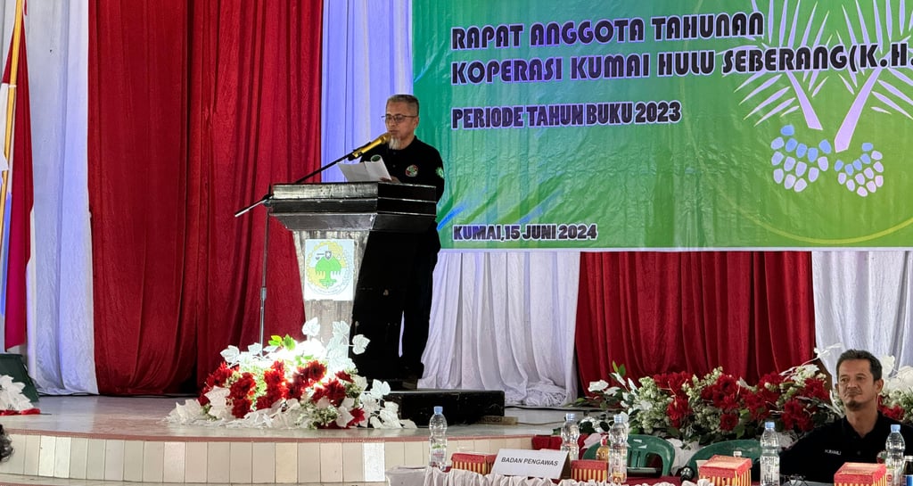 a man standing at a podium with a microphone and a microphone