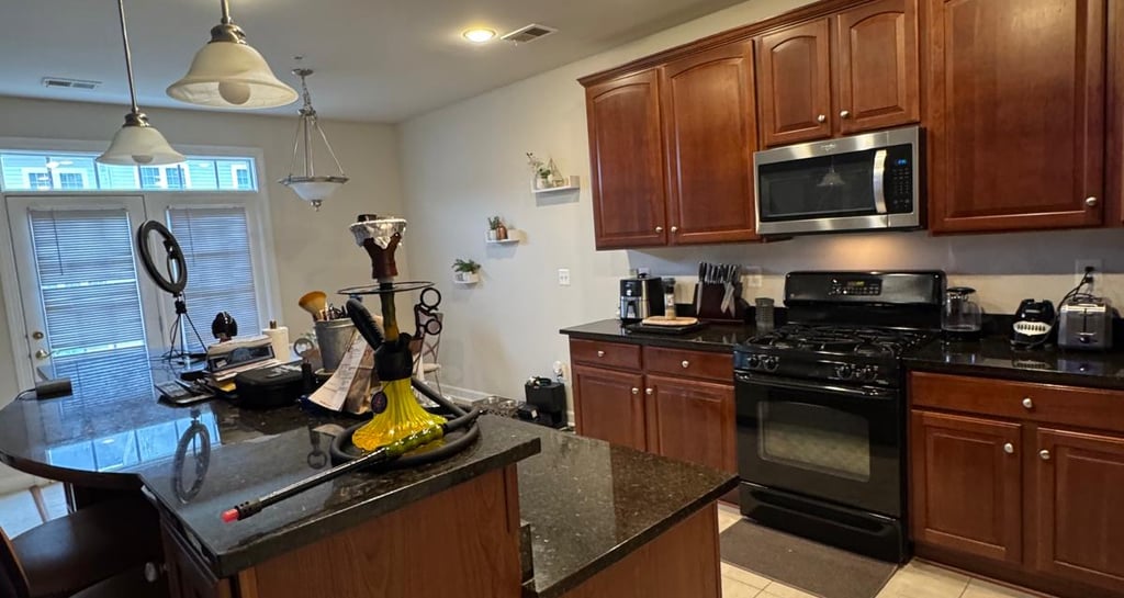 a kitchen with a stove top oven and a microwave