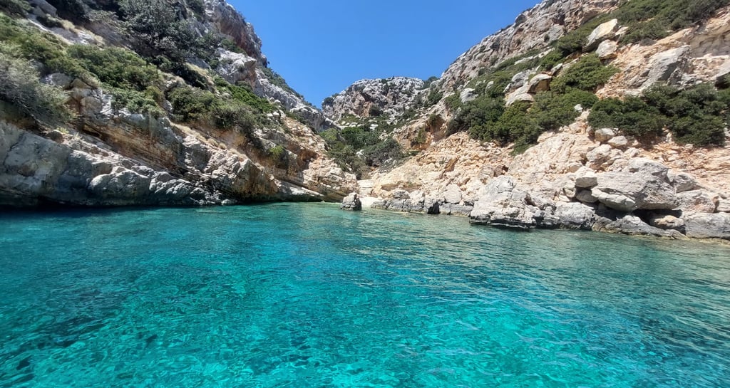 a boat in the water near a mountain