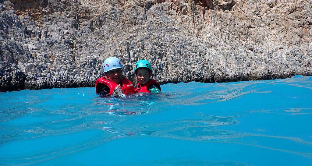 two people in life jackets in the water