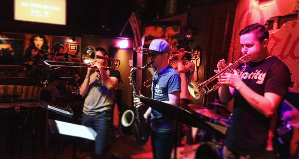 a band playing instruments in a brass band, portland oregon, mardi gras, new orleans music