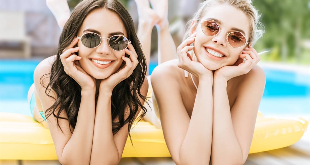 Two women relaxing on a pool float during a sunny Pool Party Crawl daylife experience