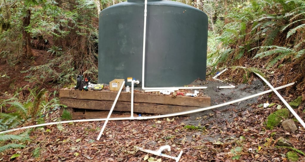 a repair of a tank of water in a wooded area