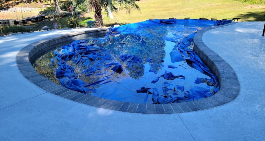 a pool with a blue tarp and a blue tarp