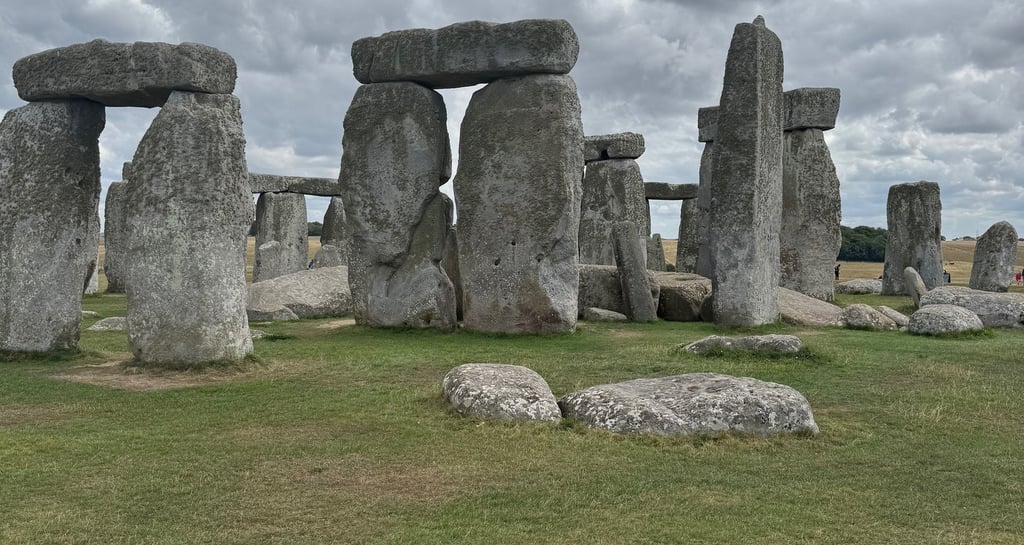 Ancient Stonehenge stone circle monument in England under a dramatic cloudy sky.