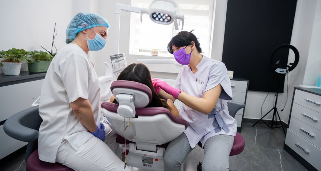 Dentist performing dental treatment on patient in modern Tbilisi clinic
