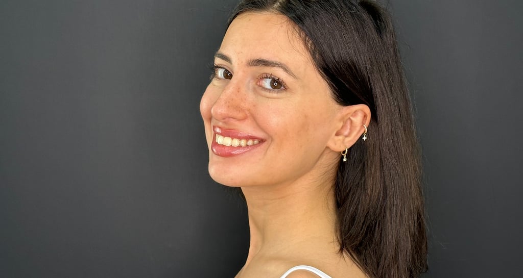 Patient smiling with natural white teeth after cosmetic dental treatment in Tbilisi
