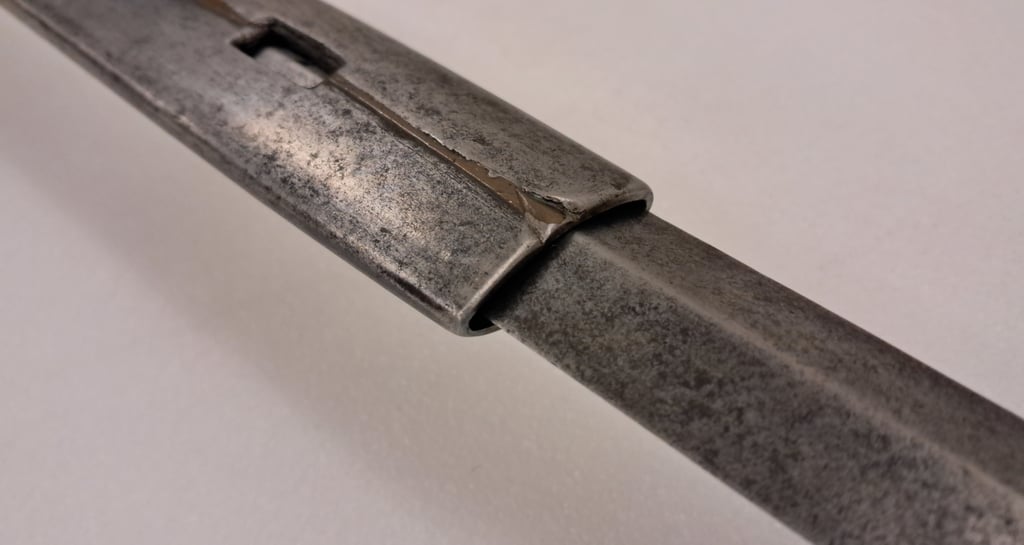 Detail of the locking notch, metal sleeve and diamondsection blade of the extending rapier.