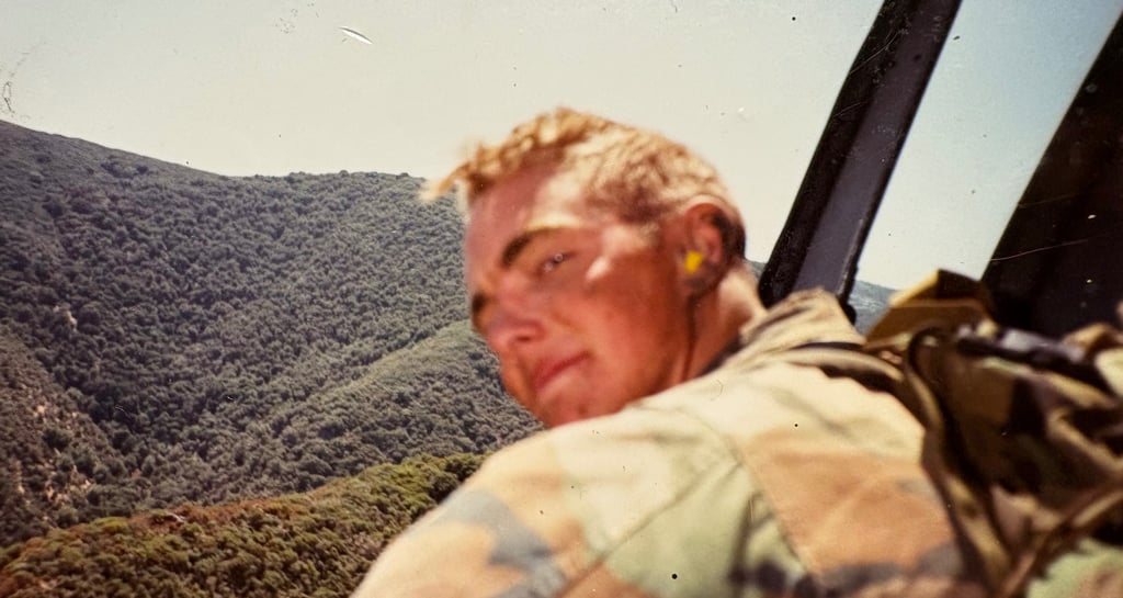 Marine Raider hanging out of a Huey