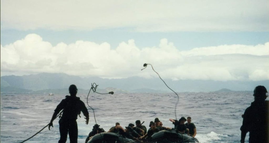 Raiders throwing a monkey's fist to recover on ship