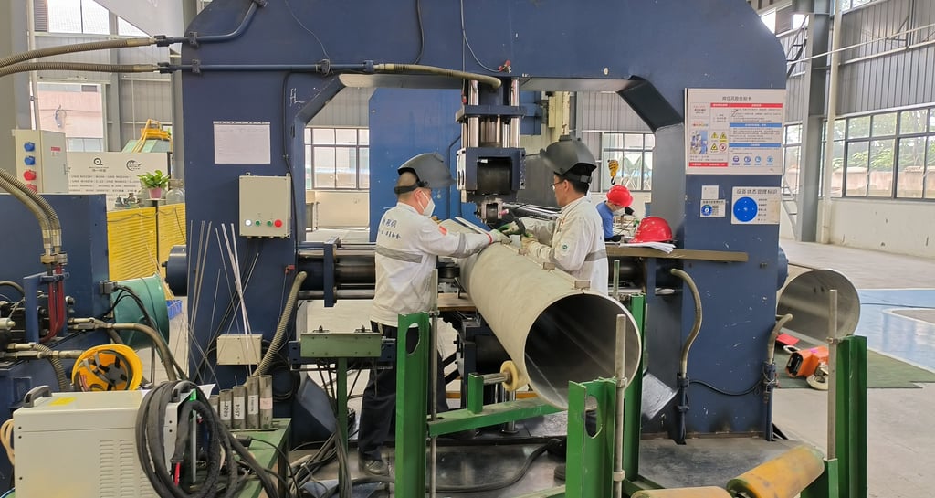 PMI Piping staff are working on welded pipes machines