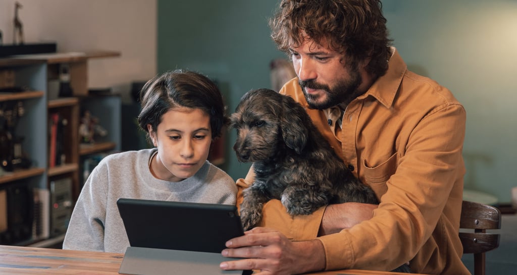 a man and a dog are sitting at a table
