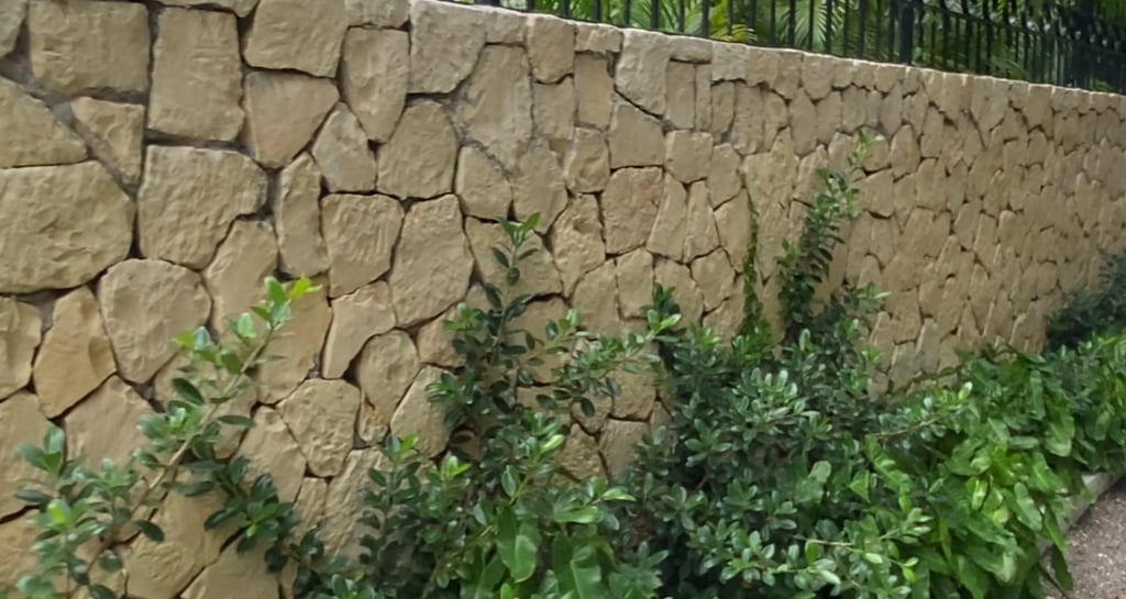 Stone wall in Jamaica built by our team of stone masons.