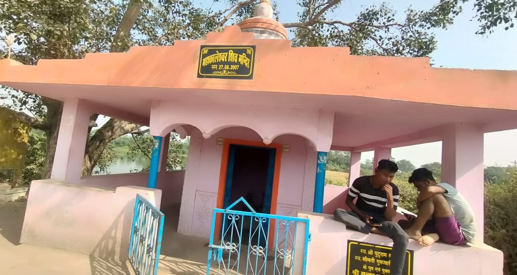 boys sit on temple boundry wall