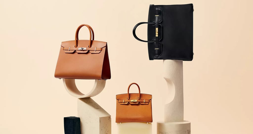 Hermes Birkin bags, Luxury tan and black handbags displayed on minimalist stone stands.