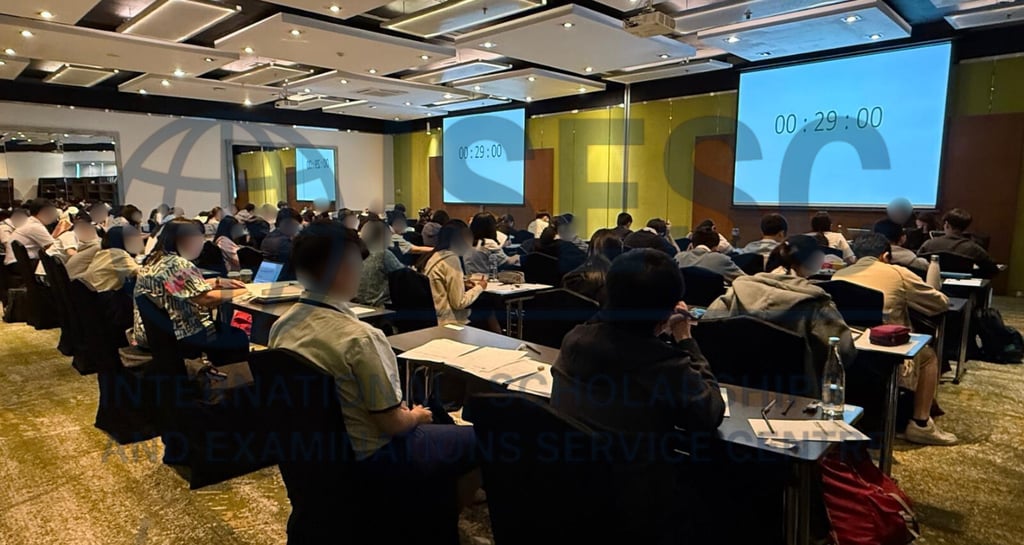 a group of people sitting at tables in a conference room