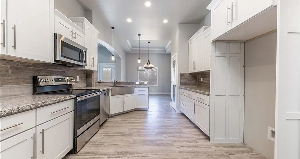 A kitchen with white cabinets of a custom home