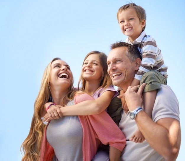 uma família de três sorrindo e rindo juntos