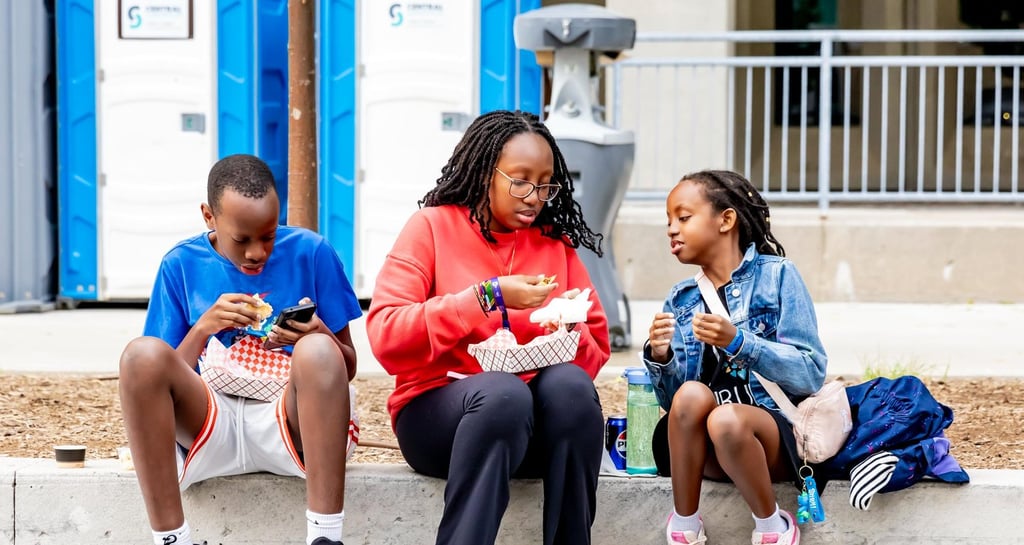 Children enjoying street food at the Afro Fiesta Festival outdoors.
