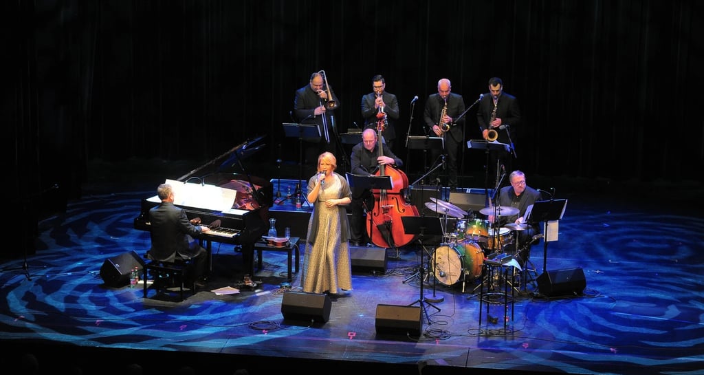 a woman in a long dress standing on a stage