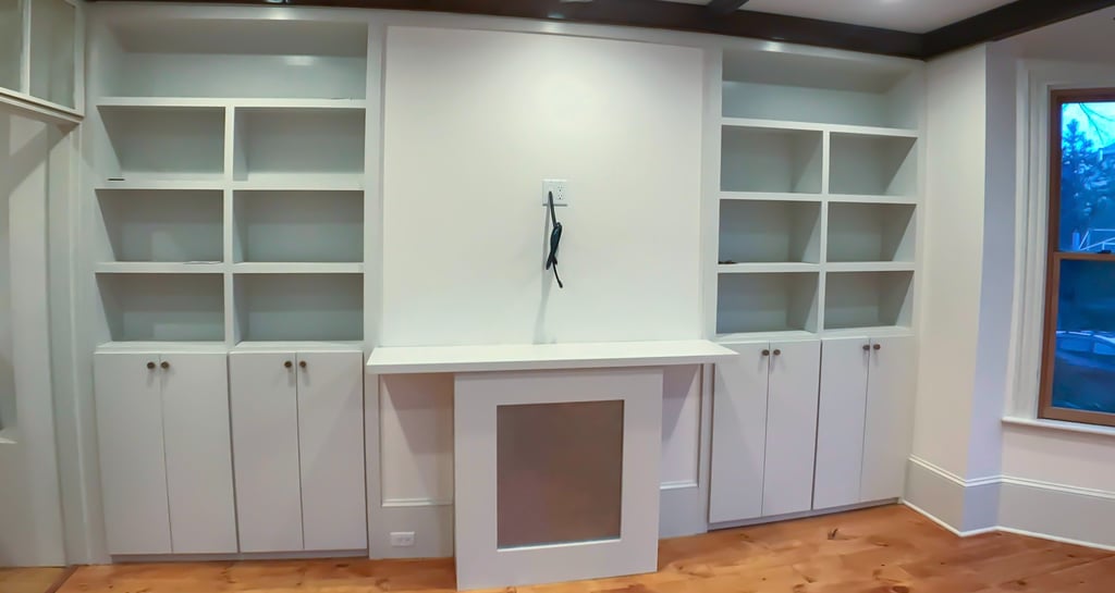 a room with a large white cabinet and a window