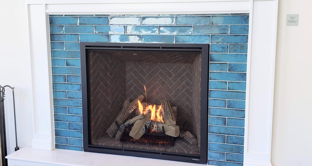 Elegant fireplace surround of blue glass tile and painted white frame and mantle. Hearth and mantle work in Colorado Springs.