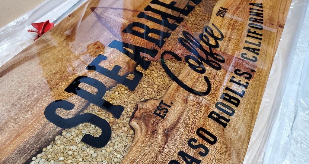 Custom live edge and resin river table top. Coffee beans fill the river with a logo CNC'd in the epoxy. 