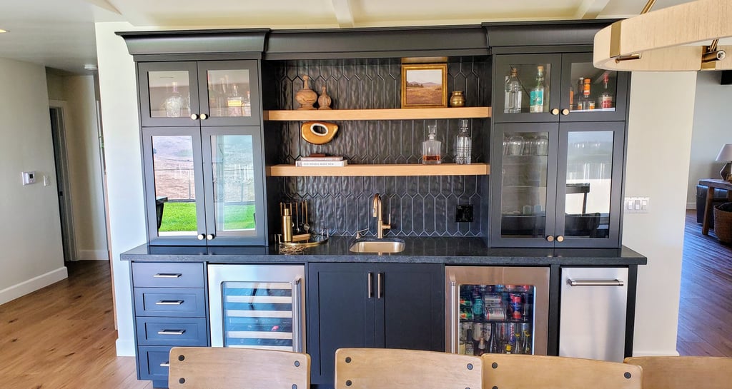Custom black cabinet wet bar with glass paneled doors and custom natural wood shelving. Colorado Springs carpentry.