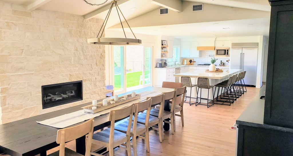 open dining room with stone work fireplace surround and open fully renovated kitchen. Colorado Springs.