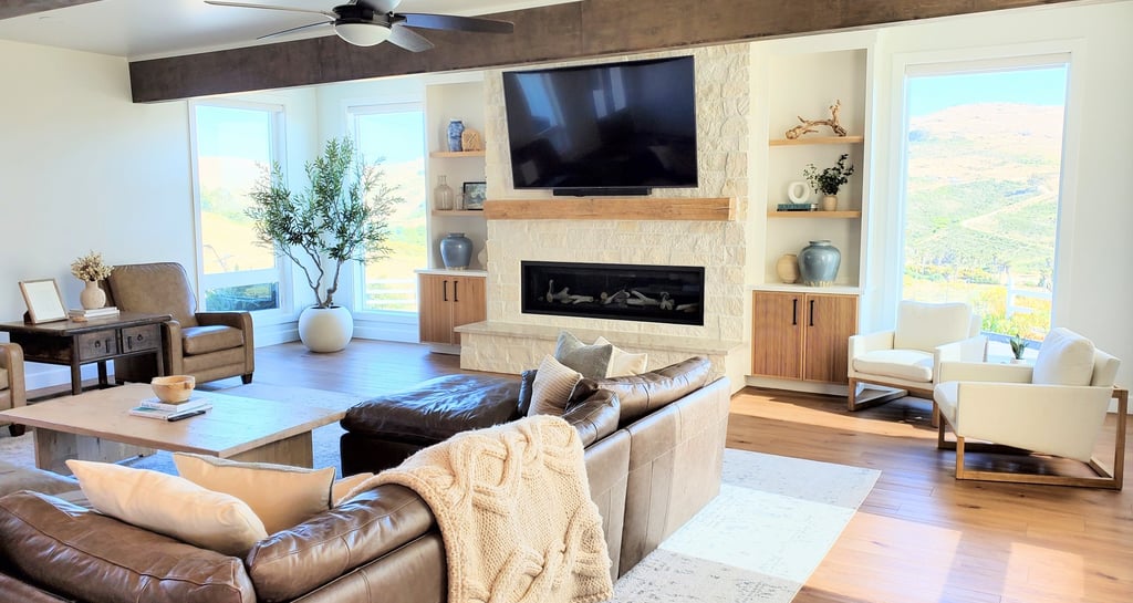 Living room remodel with exposed beams, white stone work fireplace with natural wood mantle.