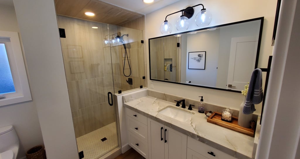 Compete bathroom renovation with recessed lights, sleek shower and counter top. personalized bathrooms Colorado Springs.