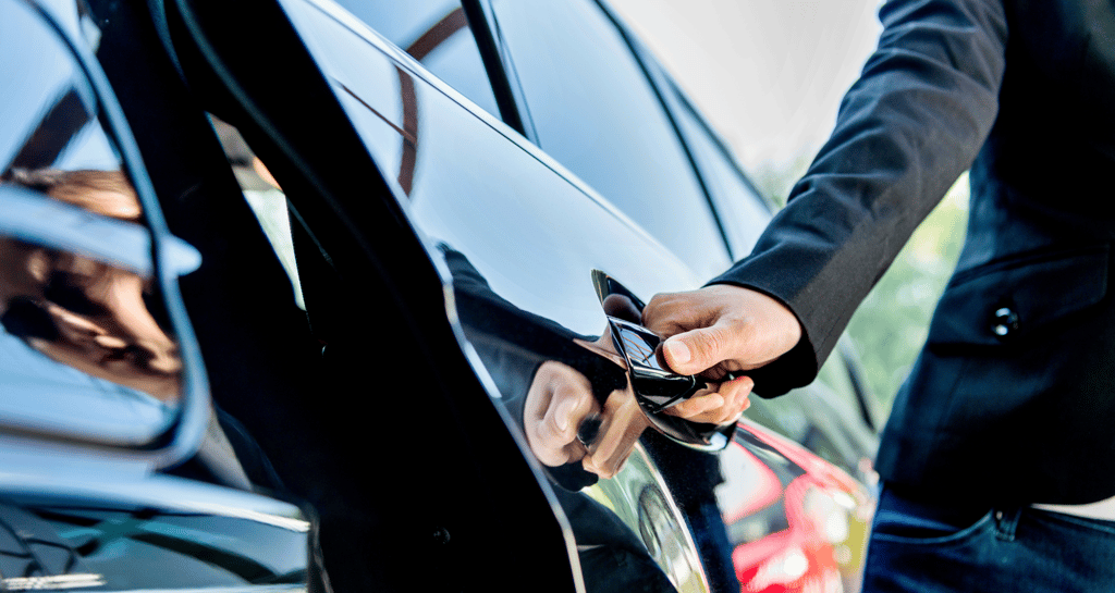 a man in a suit and tie is holding a cell phone
